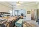 Inviting main bedroom offers a seating area and view to ensuite bathroom at 152 Ridge Xing, Temple, GA 30179