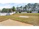 Large, grassy backyard with a white fence, a small tree, and a concrete patio at 362 Interlake Pass, Mcdonough, GA 30252