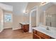 Bright bathroom featuring a dual sink vanity, wood flooring, and natural light at 362 Interlake Pass, Mcdonough, GA 30252
