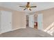 Neutral bedroom with ceiling fan and adjoining bathroom, providing a peaceful retreat at 362 Interlake Pass, Mcdonough, GA 30252