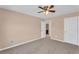 Spacious bedroom featuring neutral walls, plush carpet, ceiling fan, and ample natural light at 362 Interlake Pass, Mcdonough, GA 30252