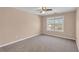 Bedroom with neutral carpet, ceiling fan, and a large window with a neighborhood view at 362 Interlake Pass, Mcdonough, GA 30252