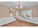 Dining room with hardwood floors, large windows, crown molding, and chandelier at 362 Interlake Pass, Mcdonough, GA 30252