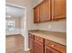 Kitchen view with wood cabinets, granite counters, and view to the dining room at 362 Interlake Pass, Mcdonough, GA 30252
