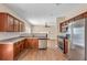 Open concept kitchen with stainless steel appliances and adjacent living space featuring a fireplace at 362 Interlake Pass, Mcdonough, GA 30252