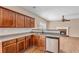 Kitchen features stainless appliances, wood cabinets, and an open design leading to the living room with fireplace at 362 Interlake Pass, Mcdonough, GA 30252