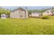 Exterior shot showcasing a grassy backyard, wood fence, and the rear of a two-story home at 4139 Kensington Cv, Atlanta, GA 30349