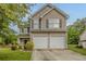 Charming two-story home with a two-car garage, neutral siding, and well-maintained landscaping at 4139 Kensington Cv, Atlanta, GA 30349