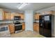Bright kitchen with wooden cabinets and stainless steel appliances at 4139 Kensington Cv, Atlanta, GA 30349