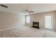 Spacious living room with fireplace, ceiling fan, and door to exterior at 4139 Kensington Cv, Atlanta, GA 30349