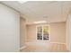 The finished basement area has light colored wood-look floors, neutral paint, and a door to the backyard at 415 Collegiate Dr, Powder Springs, GA 30127