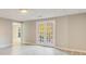 Finished basement with door to backyard, featuring light colored wood-look floors and neutral colored walls at 415 Collegiate Dr, Powder Springs, GA 30127