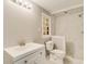 Bathroom showcases a white vanity, toilet, and tiled shower, with a window providing natural light at 415 Collegiate Dr, Powder Springs, GA 30127