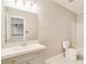 Bright bathroom featuring a gray vanity with a white countertop and a large mirror at 415 Collegiate Dr, Powder Springs, GA 30127