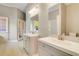 Bright bathroom features double sink vanity with modern fixtures and mirrors, and neutral paint at 415 Collegiate Dr, Powder Springs, GA 30127