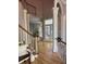 Light-filled foyer featuring hardwood floors, white pillars, high ceilings, and view into the living space at 415 Collegiate Dr, Powder Springs, GA 30127
