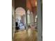 Spacious foyer with arched openings, wood floors, and view into the living space with fireplace and large windows at 415 Collegiate Dr, Powder Springs, GA 30127
