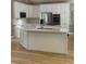 Modern kitchen featuring white cabinets, stainless steel appliances, and a large center island at 415 Collegiate Dr, Powder Springs, GA 30127