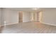 Open-concept living room with light gray walls and wood-look floors, creating a bright and inviting space at 415 Collegiate Dr, Powder Springs, GA 30127
