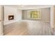 Spacious living room featuring a painted brick fireplace and large window providing ample natural light at 415 Collegiate Dr, Powder Springs, GA 30127