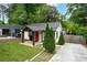 Charming single-story home with a bright red door, fresh exterior paint, and a cozy, manicured front yard at 360 New Jersey Nw Ave, Atlanta, GA 30314
