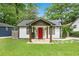 Charming home featuring a well-manicured lawn, stone walkway, and a vibrant red front door at 360 New Jersey Nw Ave, Atlanta, GA 30314
