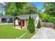 Exterior view of a home with a well-maintained lawn, driveway, and welcoming red front door at 360 New Jersey Nw Ave, Atlanta, GA 30314