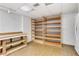 Unfinished basement space with utility shelving and work area at 1020 Riverside Rd, Roswell, GA 30076