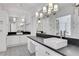 A well-lit bathroom featuring double sinks with dark countertops, decorative tile floors, and modern fixtures at 1020 Riverside Rd, Roswell, GA 30076