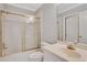 Bathroom featuring a shower with gold trim, a sink and toilet at 1020 Riverside Rd, Roswell, GA 30076