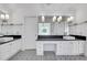 Bathroom featuring double sinks, a makeup vanity area, decorative tile floors, and modern lighting fixtures at 1020 Riverside Rd, Roswell, GA 30076