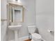 A bathroom with a pedestal sink and toilet at 1020 Riverside Rd, Roswell, GA 30076