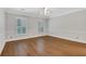 Empty bedroom featuring a ceiling fan, hardwood floors and window shutters at 1020 Riverside Rd, Roswell, GA 30076