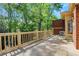 Spacious outdoor deck with railing offers beautiful views of the surrounding trees and greenery at 1020 Riverside Rd, Roswell, GA 30076
