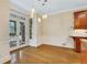 A dining room with wood cabinets and flooring with access to a patio at 1020 Riverside Rd, Roswell, GA 30076