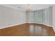 Light-filled dining room with hardwood floors and crown molding, illuminated by a chandelier at 1020 Riverside Rd, Roswell, GA 30076