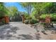Gated brick entrance to a private community with lush landscaping and blooming flowers at 1020 Riverside Rd, Roswell, GA 30076