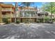Multi-level townhome featuring balconies, brick facade and lush landscaping at 1020 Riverside Rd, Roswell, GA 30076