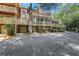 Multi-level townhome with brick facade, balconies, and covered parking at 1020 Riverside Rd, Roswell, GA 30076