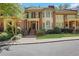 Charming brick townhome with well-maintained landscaping and inviting front entrance at 1020 Riverside Rd, Roswell, GA 30076