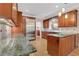 A spacious kitchen featuring granite counters, stainless steel appliances and wood cabinetry at 1020 Riverside Rd, Roswell, GA 30076