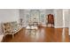 Sunlit living room with hardwood floors, traditional furniture, and a large window at 1020 Riverside Rd, Roswell, GA 30076