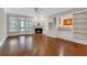 Living room with hardwood floors, fireplace, built-in shelving, and ample natural light creating an inviting gathering space at 1020 Riverside Rd, Roswell, GA 30076