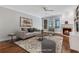 Bright, staged living room featuring hardwood floors, fireplace, and large windows, creating a bright and inviting space at 1020 Riverside Rd, Roswell, GA 30076