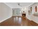 Living room featuring hardwood floors, a fireplace, built-in shelving and plenty of natural light creating an inviting space at 1020 Riverside Rd, Roswell, GA 30076