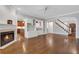 Living room featuring a fireplace, built-in shelves, ceiling fan, and hardwood floors, creating a comfortable gathering space at 1020 Riverside Rd, Roswell, GA 30076