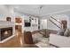 Bright living room with fireplace, built-in shelving, and open layout, enhanced by a ceiling fan and ample light at 1020 Riverside Rd, Roswell, GA 30076