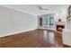 Open living area with hardwood flooring, a fireplace, and plenty of natural light from the surrounding windows at 1020 Riverside Rd, Roswell, GA 30076