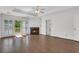 Bright main bedroom with hardwood floors, a fireplace, ceiling fan, and access to an outdoor balcony at 1020 Riverside Rd, Roswell, GA 30076