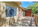 View of brick home's rear patio featuring a stained glass window and wooden railing at 1020 Riverside Rd, Roswell, GA 30076